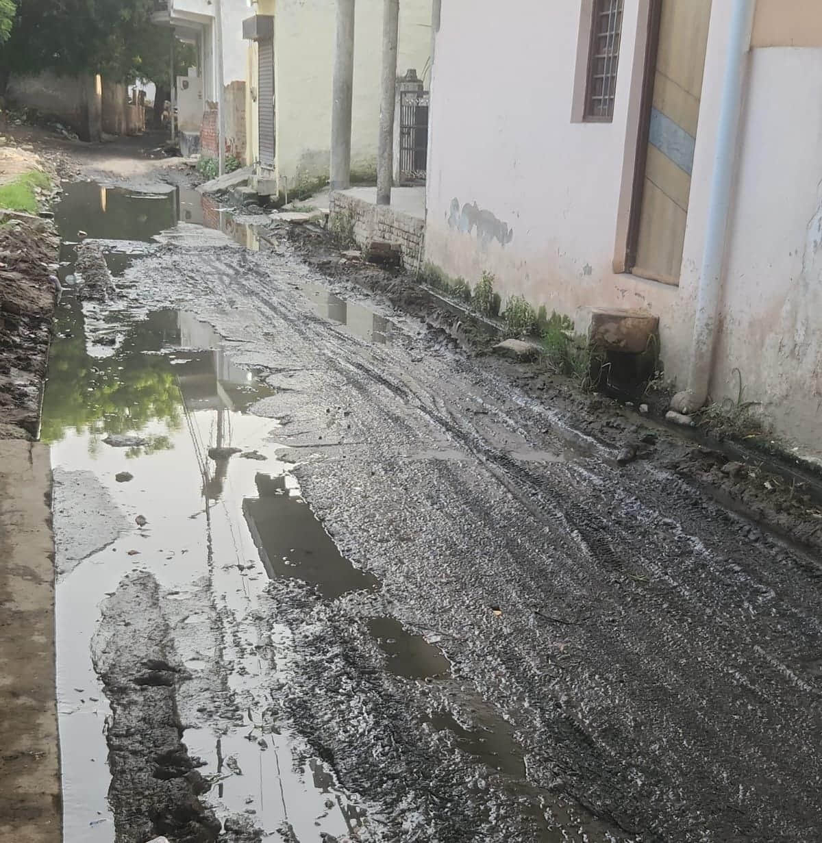 Waterlogging on the road due to drain overflow.