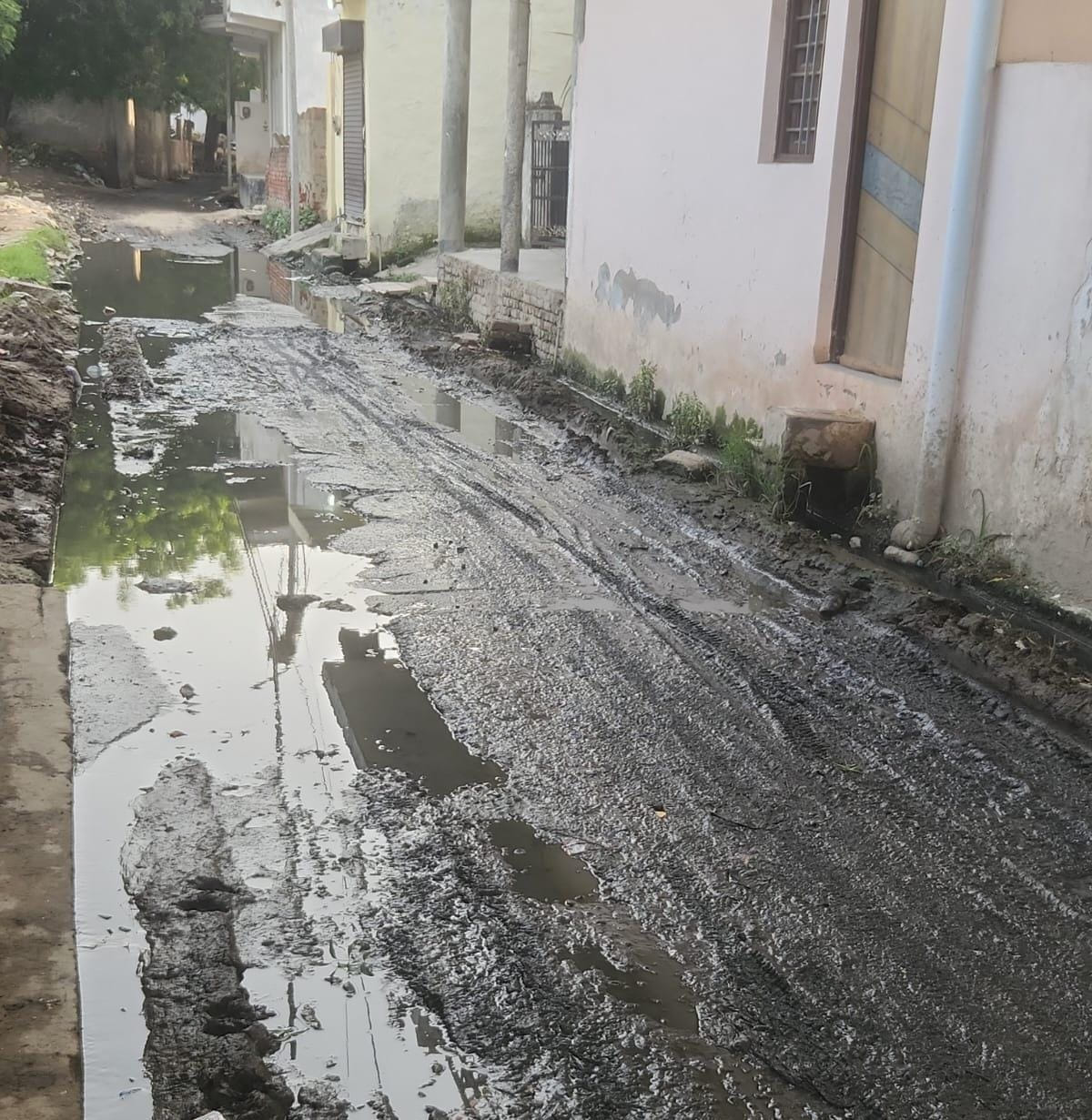 Waterlogging on the road due to drain overflow.