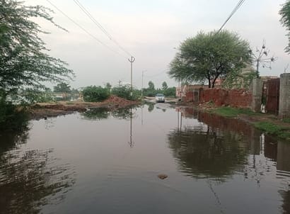 Waterlogging has become a problem in Calleram village; villagers are forced to wade through dirty water.