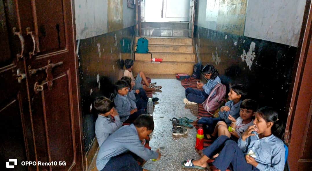 Young children shaping their future while sitting on the ground.
