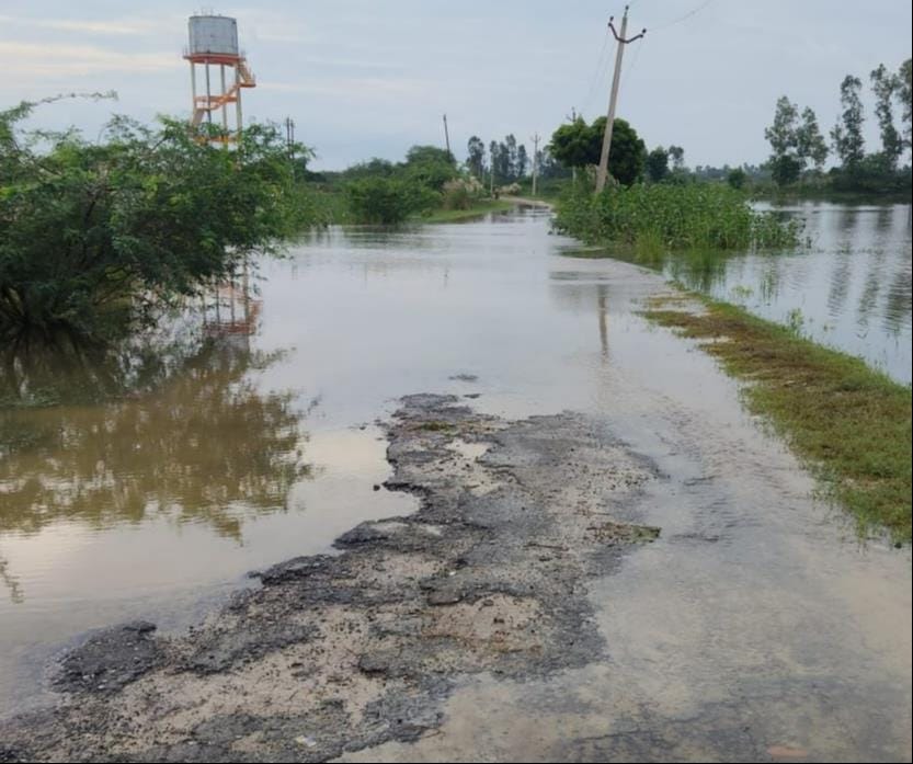 Commuting by boat in Bilgram; huts flooded with water.
