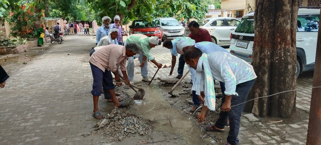 A team of sanitation workers cleaned the clogged drain.