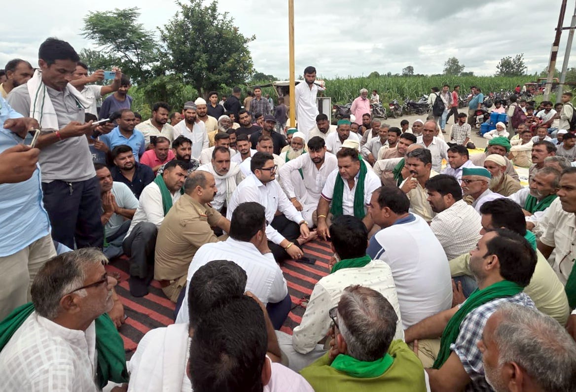 Farmers protest and stage a sit-in to get closed cuts on the National Highway reopened.