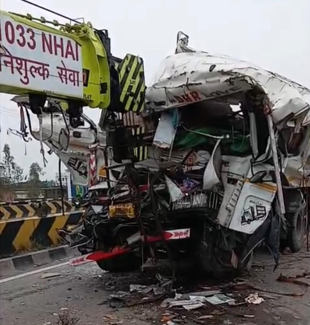 Second truck collides with truck parked on highway; driver dies.