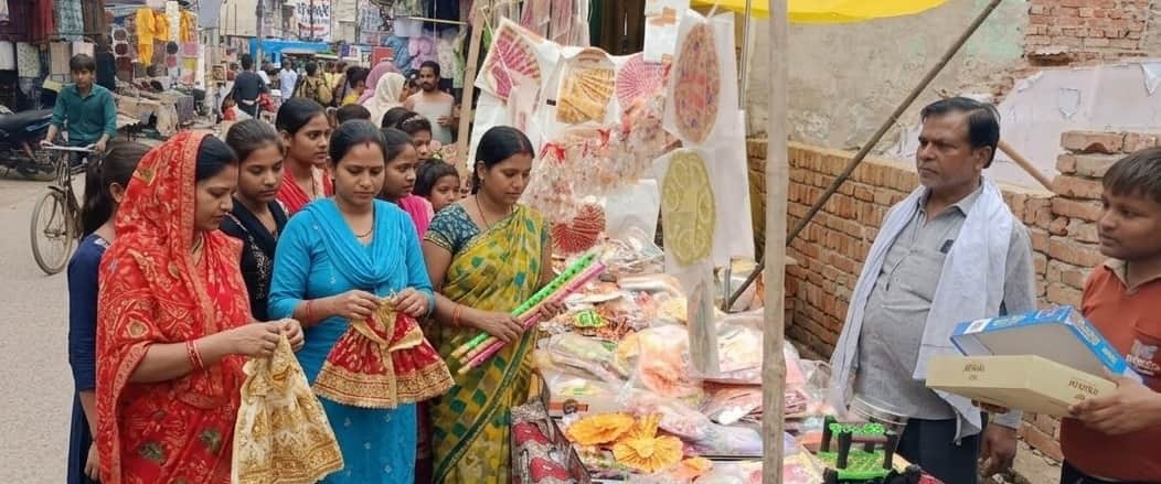 Shops adorned with Laddu Gopal's outfits, crowns, and flutes.