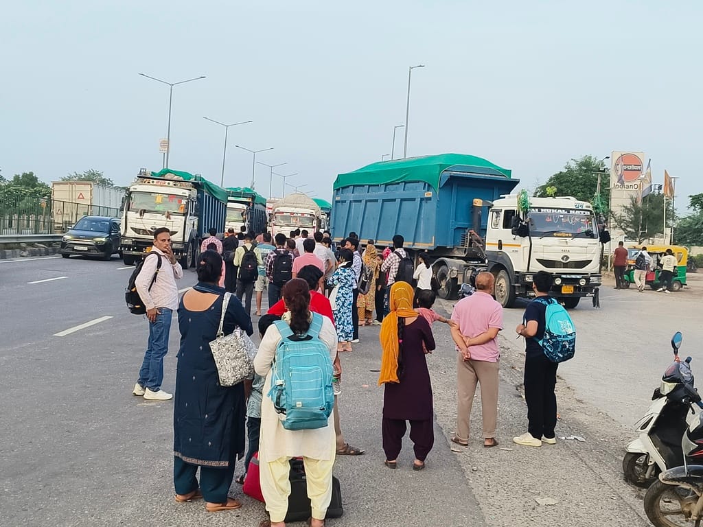 Vehicles parked on the Dharuhera highway cause traffic jams; risk of accidents.