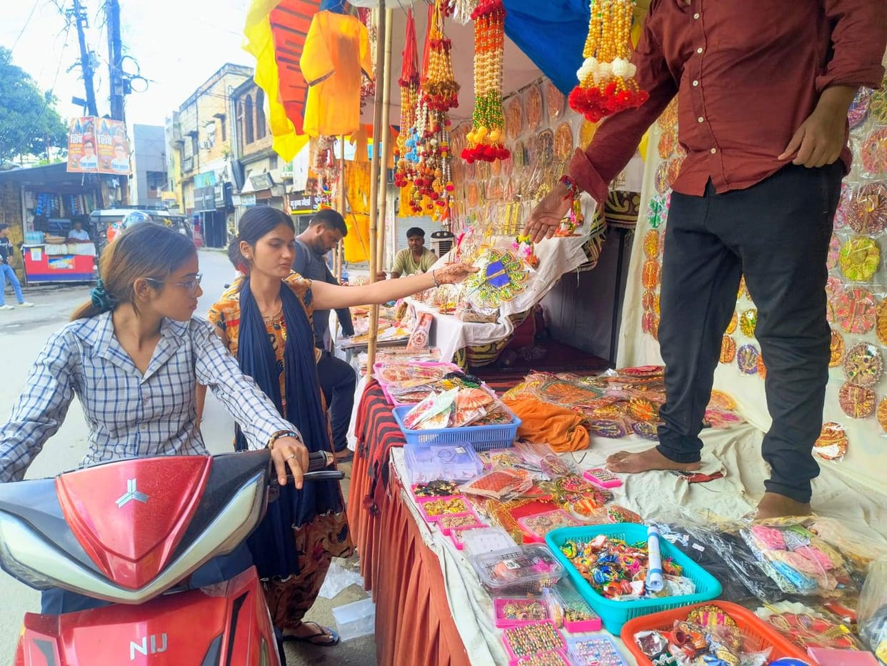 The market is filled with swings, flutes, and attire for Kanha.