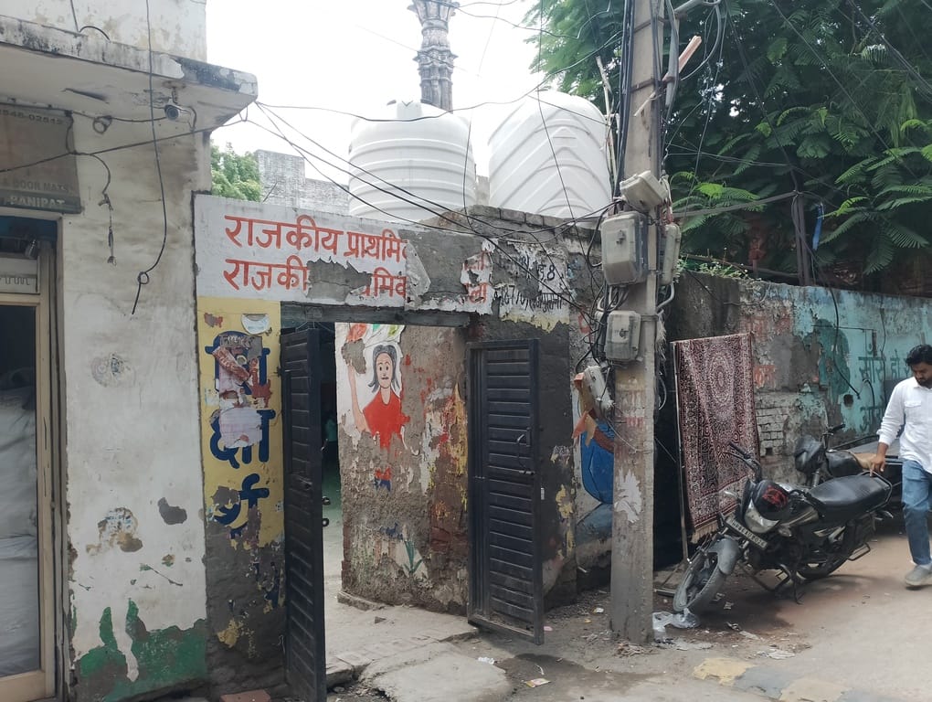 Two schools operating under a shed in the mosque; no toilets even for teachers.