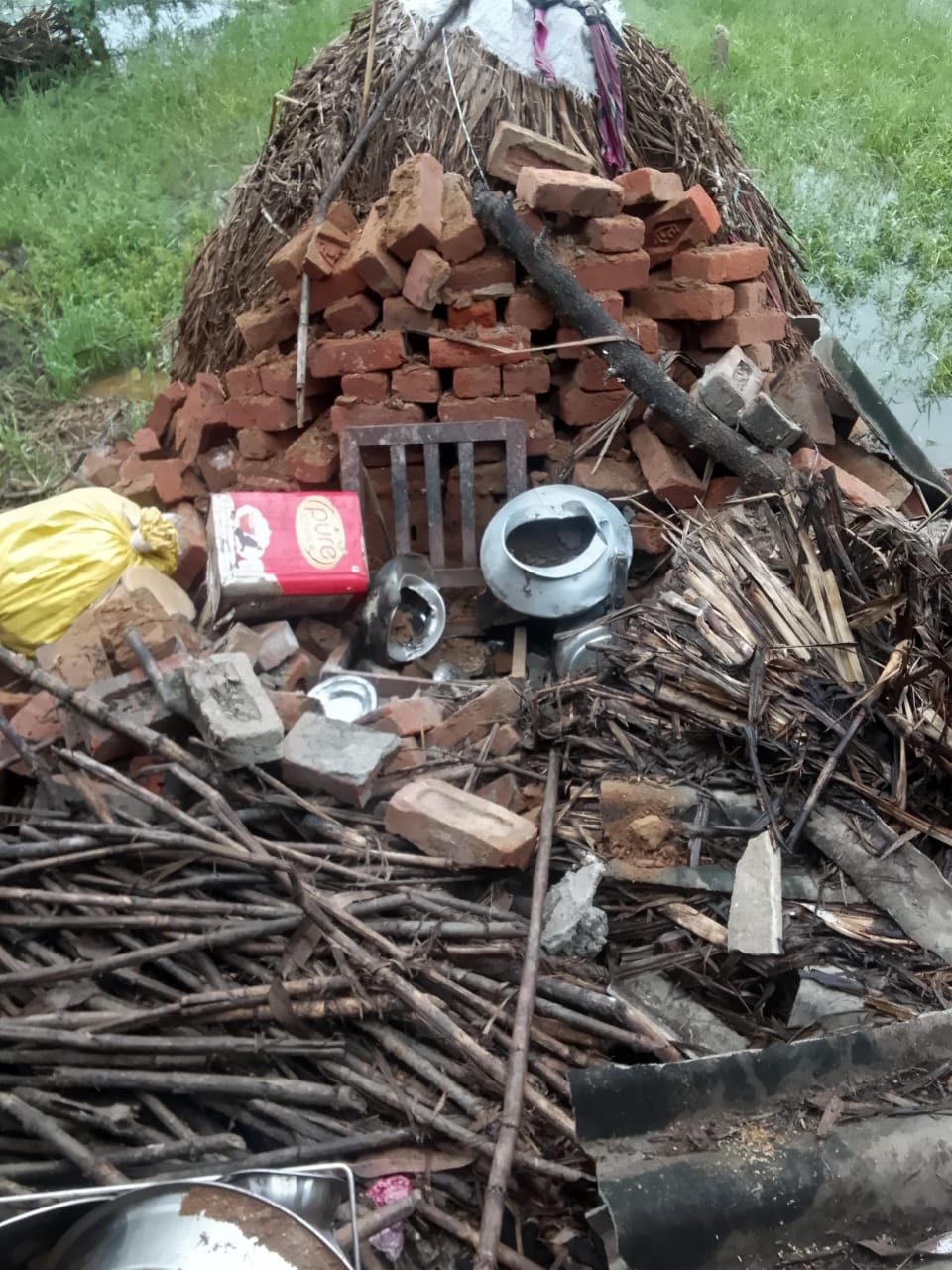 Laborer's mud house collapses in the rain; family has a narrow escape.
