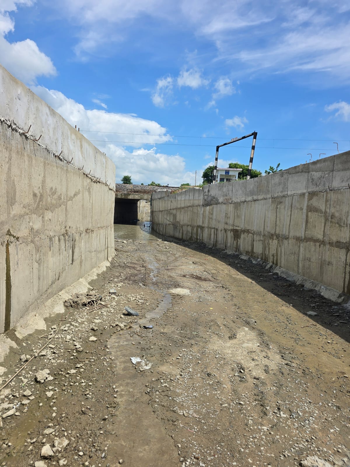Rain halts underpass construction; commute of villagers from 15 villages disrupted.