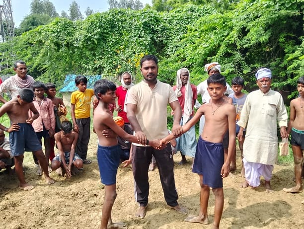 Wrestlers displayed their techniques in a children's wrestling match in Kotwari village.