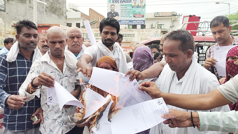 Sanitation workers expressed their protest by burning copies of the orders