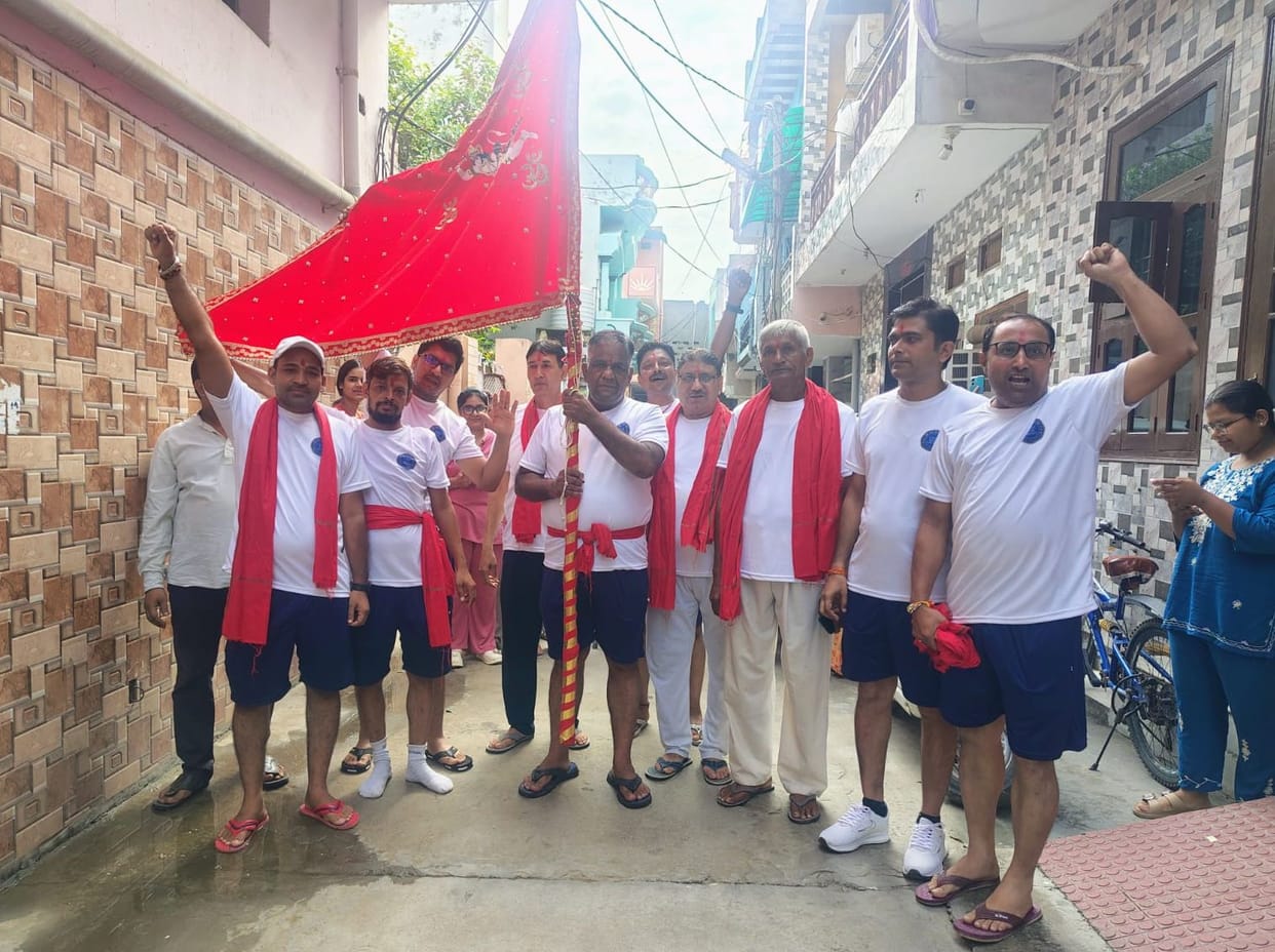 A foot procession carrying the 'Shri Ram Darbar' flag to Mehandipur Balaji.