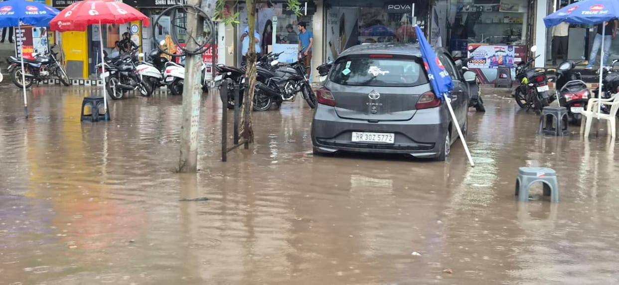 Rain slows down the city; waterlogging adds to the trouble.