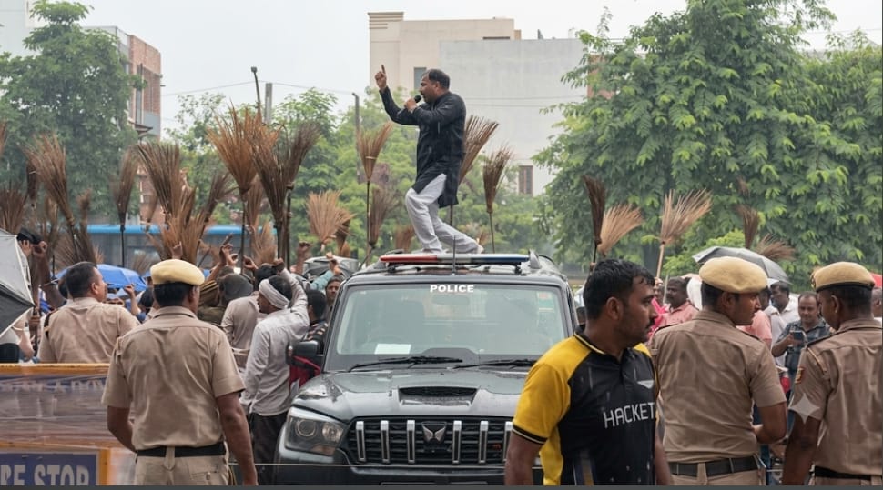 Union leader suspended for creating a ruckus by climbing onto the minister's security vehicle.