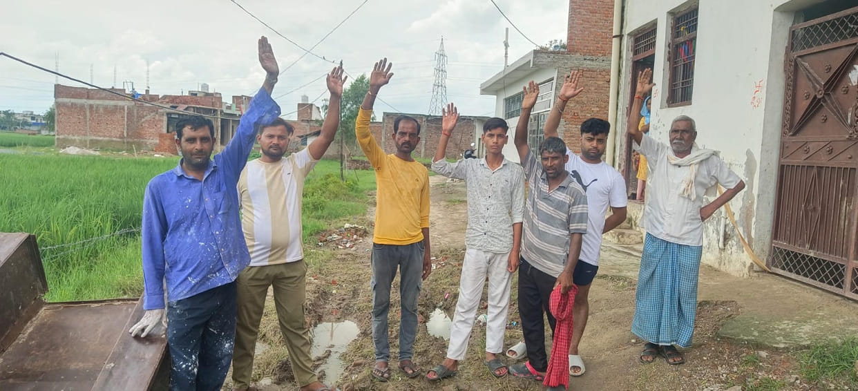 People forced to navigate a muddy road; protest.