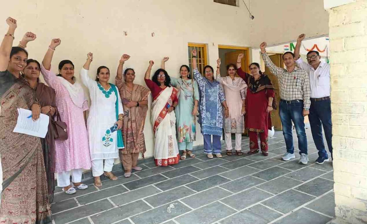 Old pension restored following High Court verdict; teachers cut cake.