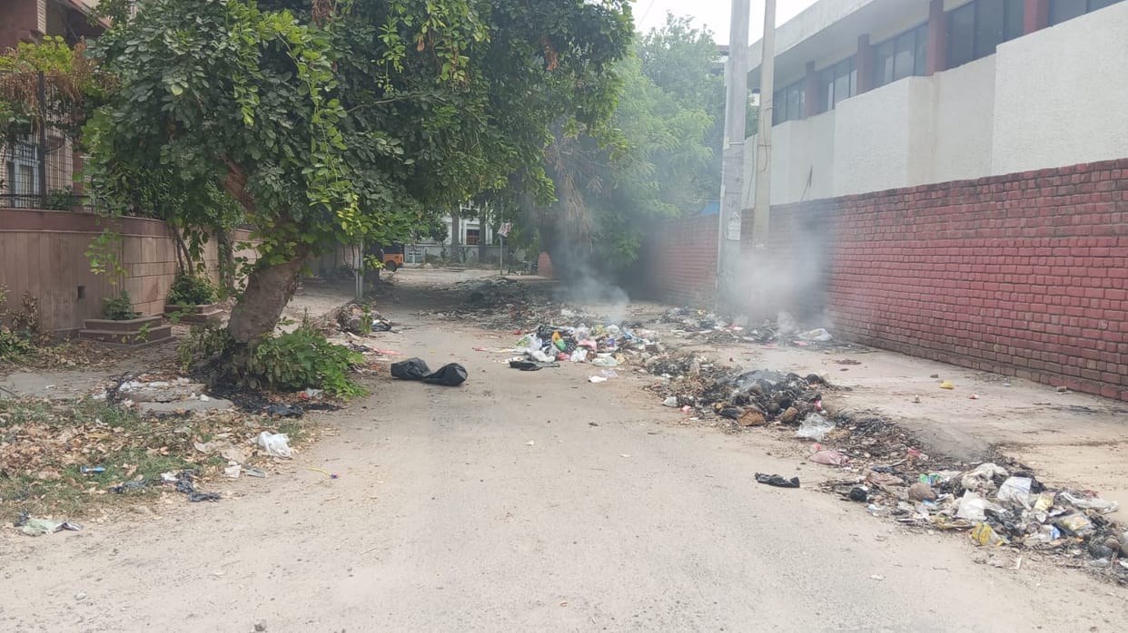 Garbage began to burn in the heat of public outrage; breath came in gasps amidst the stench and smoke.