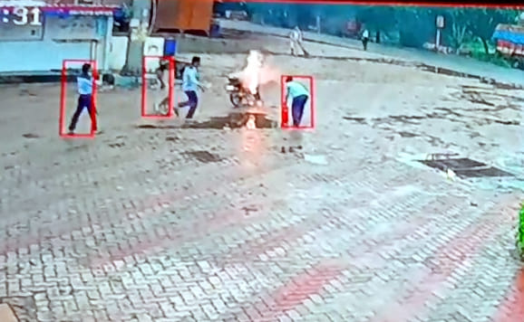 Bike catches fire at petrol pump; pump attendants extinguish it.