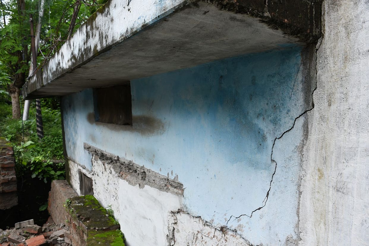 Waterlogging due to rain; drain wall collapses.
