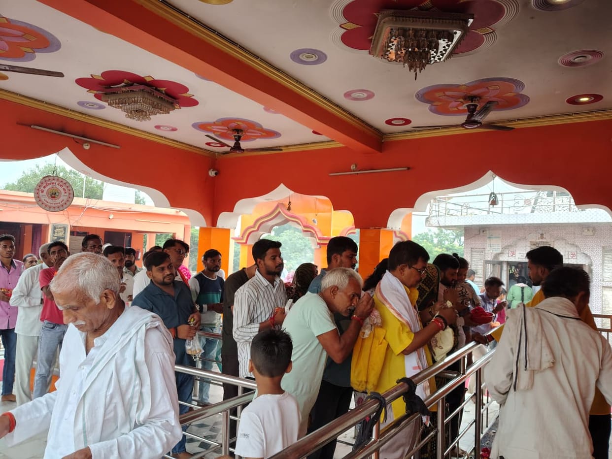 Devotees bowed their heads in reverence at the Goddess's shrine.