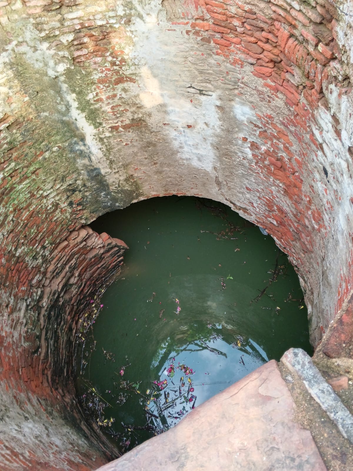 Century-old well collapses; house and temple at risk.