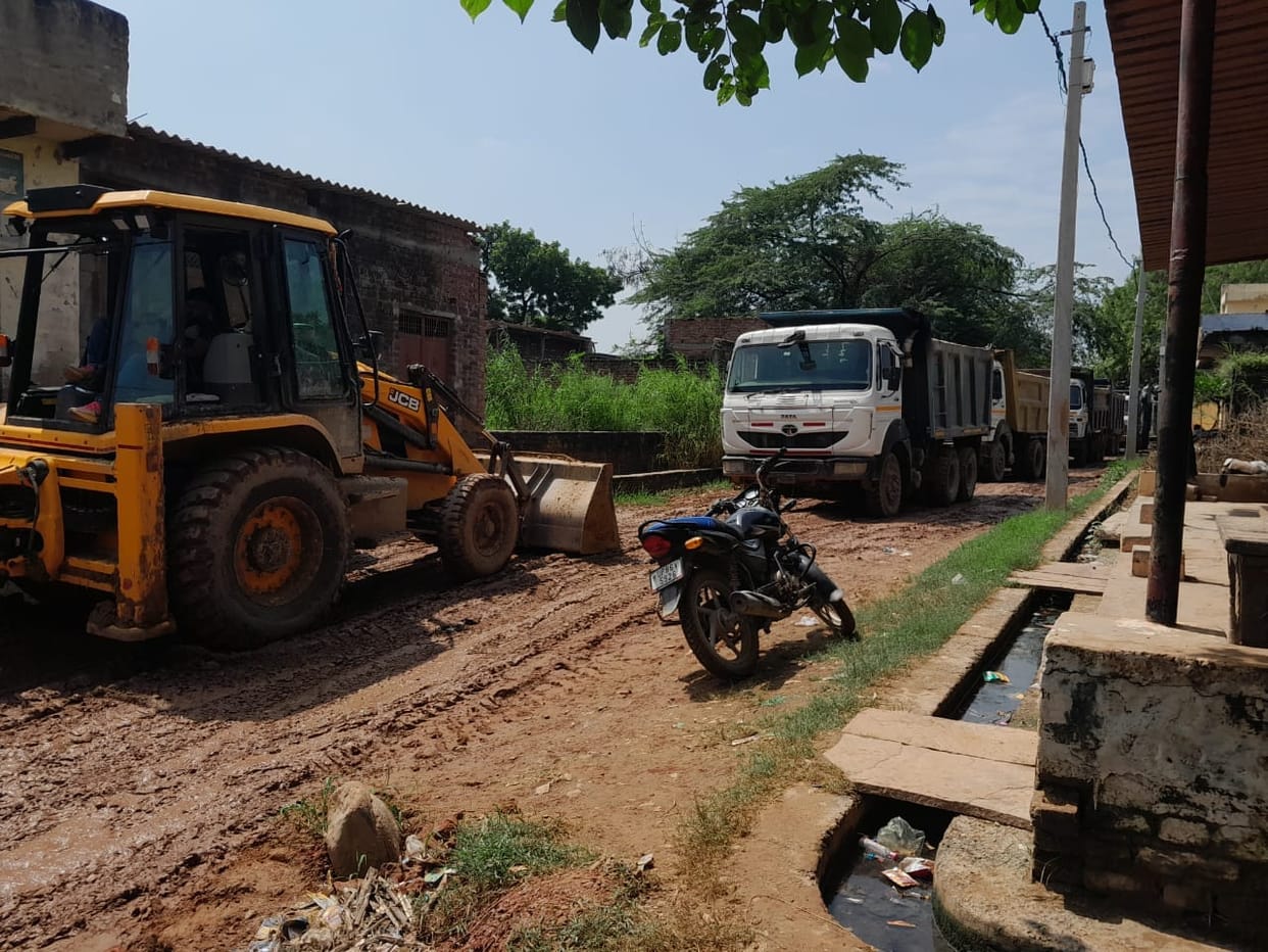 Dumpers damage bypass road; villagers block the path.