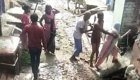 Dirty water thrown at doorway; differently-abled couple beaten up upon protesting.