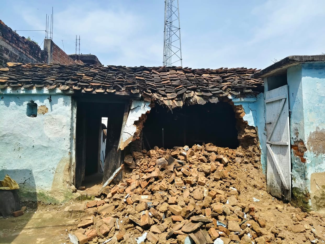 Mud house collapses; household belongings buried under the debris.