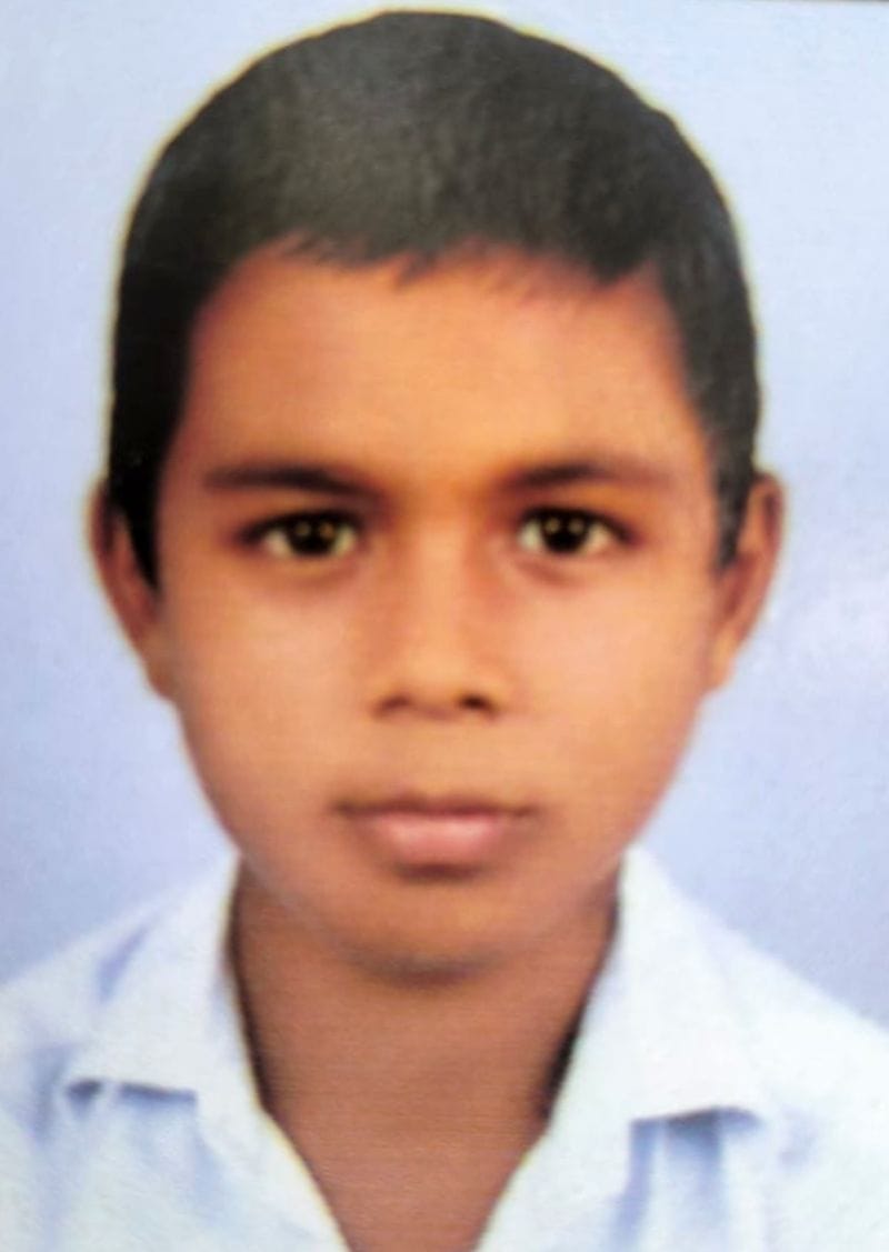 Teenager drowns after slipping while bathing in a drain; dies.