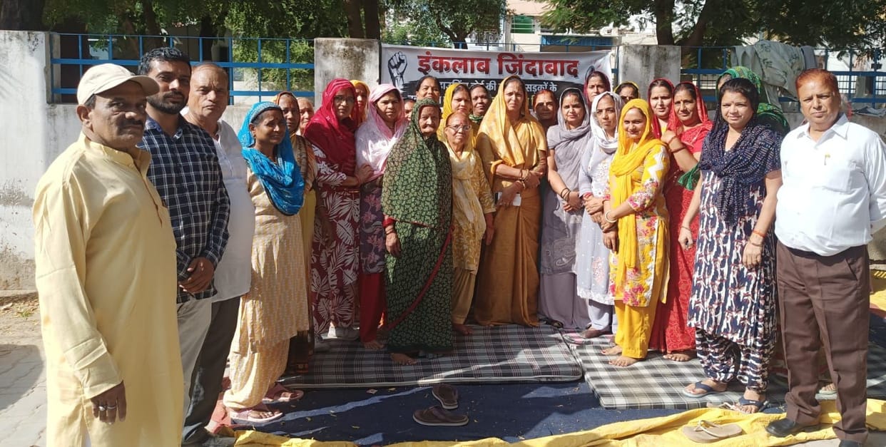 Sit-in protest called off after seven days following assurances that road construction would begin by January.