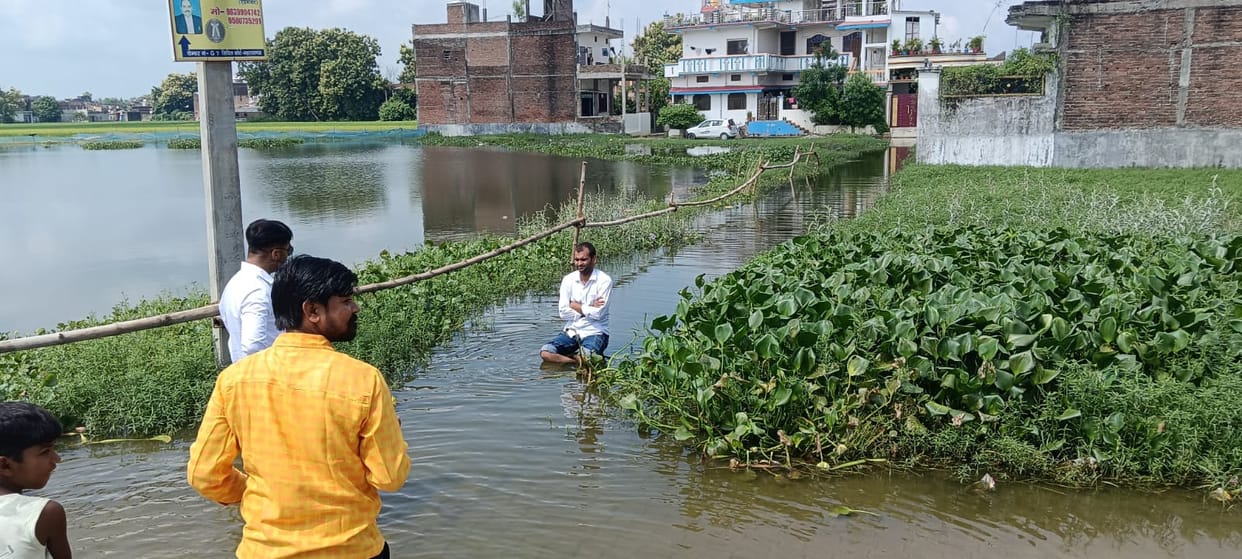 Lawyer stages hunger strike while sitting in water to protest against waterlogging.