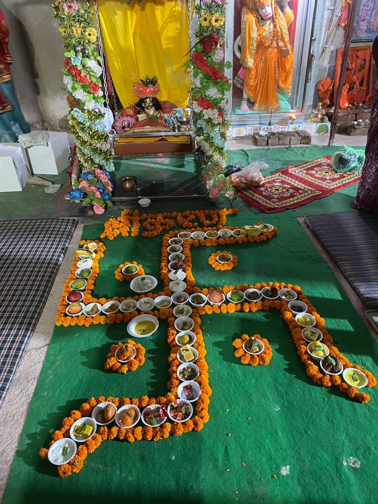 Laddu Gopal adorned for the 'Chhathi' celebration; women swayed to devotional songs and hymns.