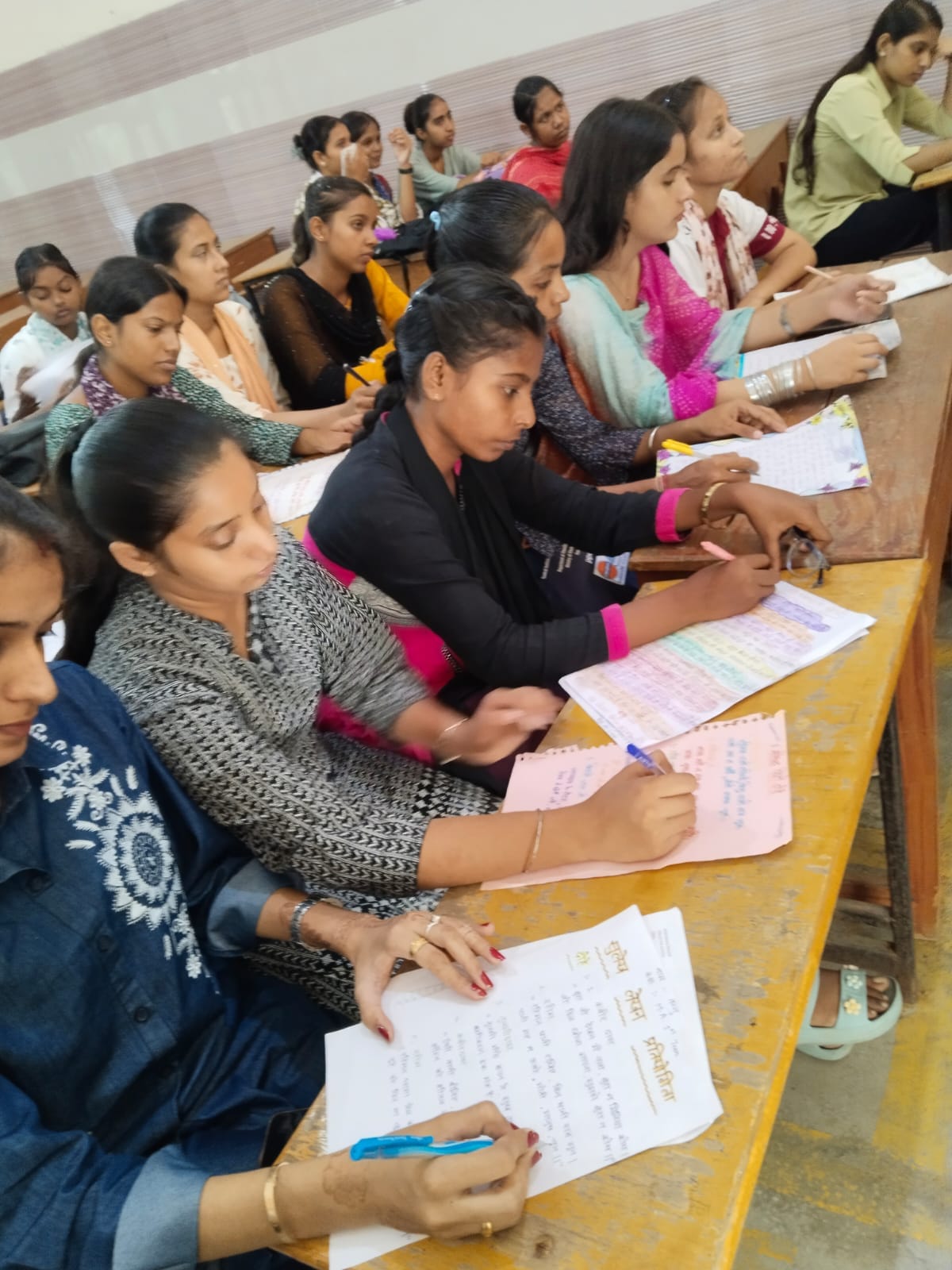 Female students wrote *dohas* (couplets) and idioms during the Hindi Fortnight.