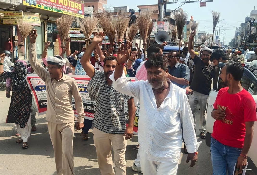 Sanitation workers staged a protest in the city holding their brooms upside down.