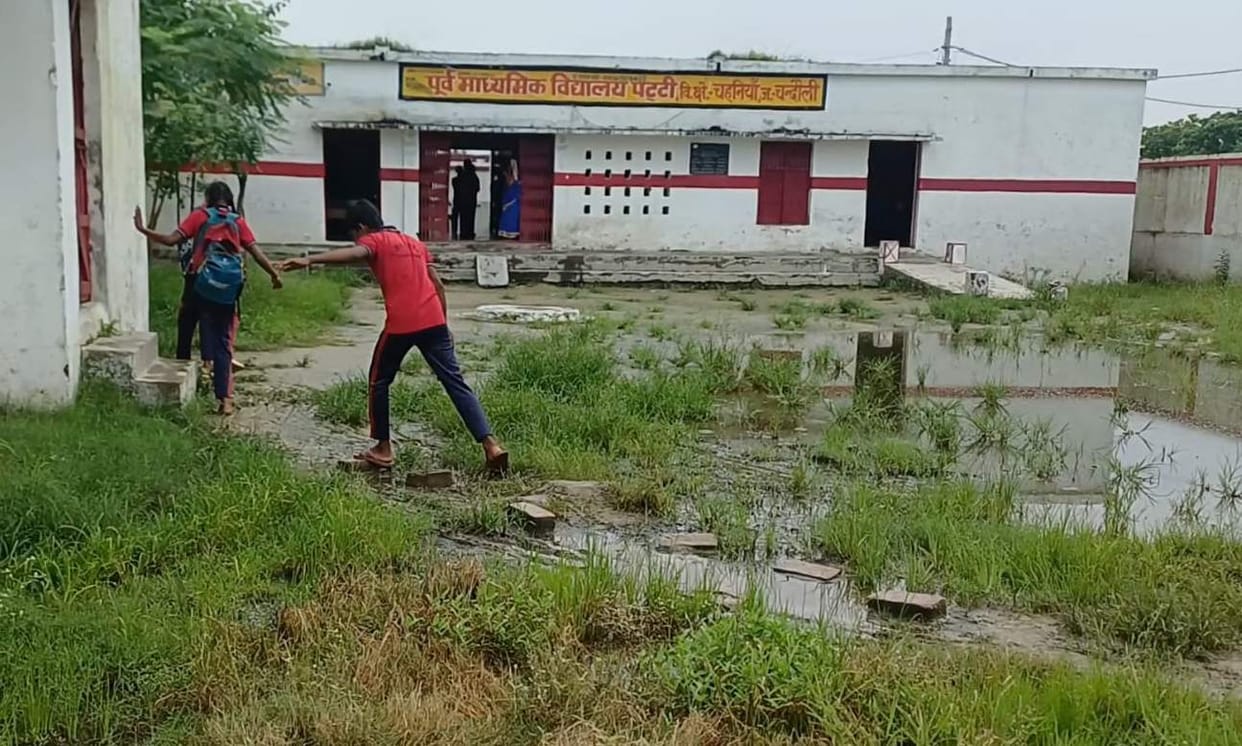 Children reaching school through water and mud
