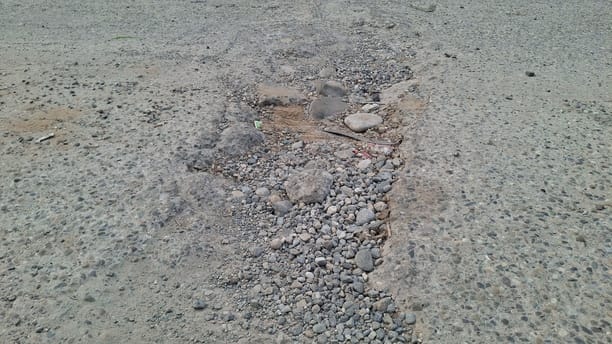 Potholes formed on the barrage bridge due to the movement of heavy vehicles