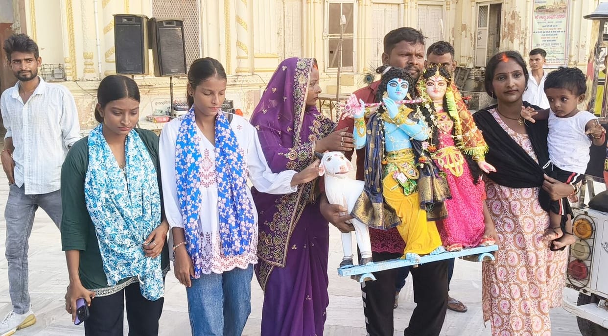 Immersion of Radha-Krishna idols amidst music and fanfare.