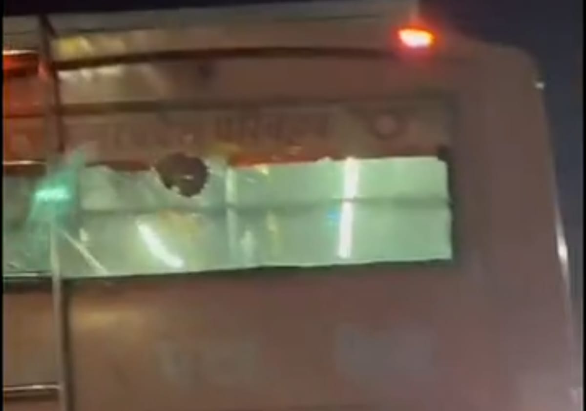 Moving roadways bus pelted with stones; rear window shattered.