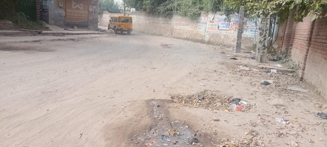 100-meter stretch of road broken for two months; residents troubled by dust and potholes.