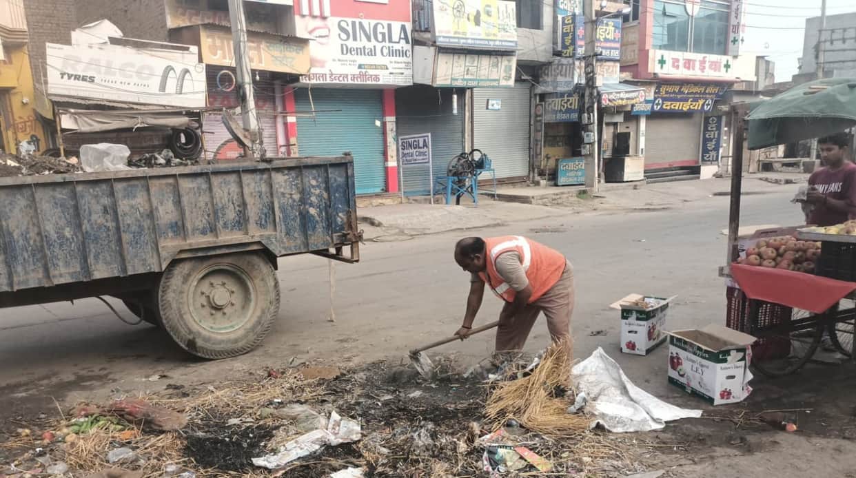 Sanitation workers took charge even on a holiday; work to clear garbage piles began.