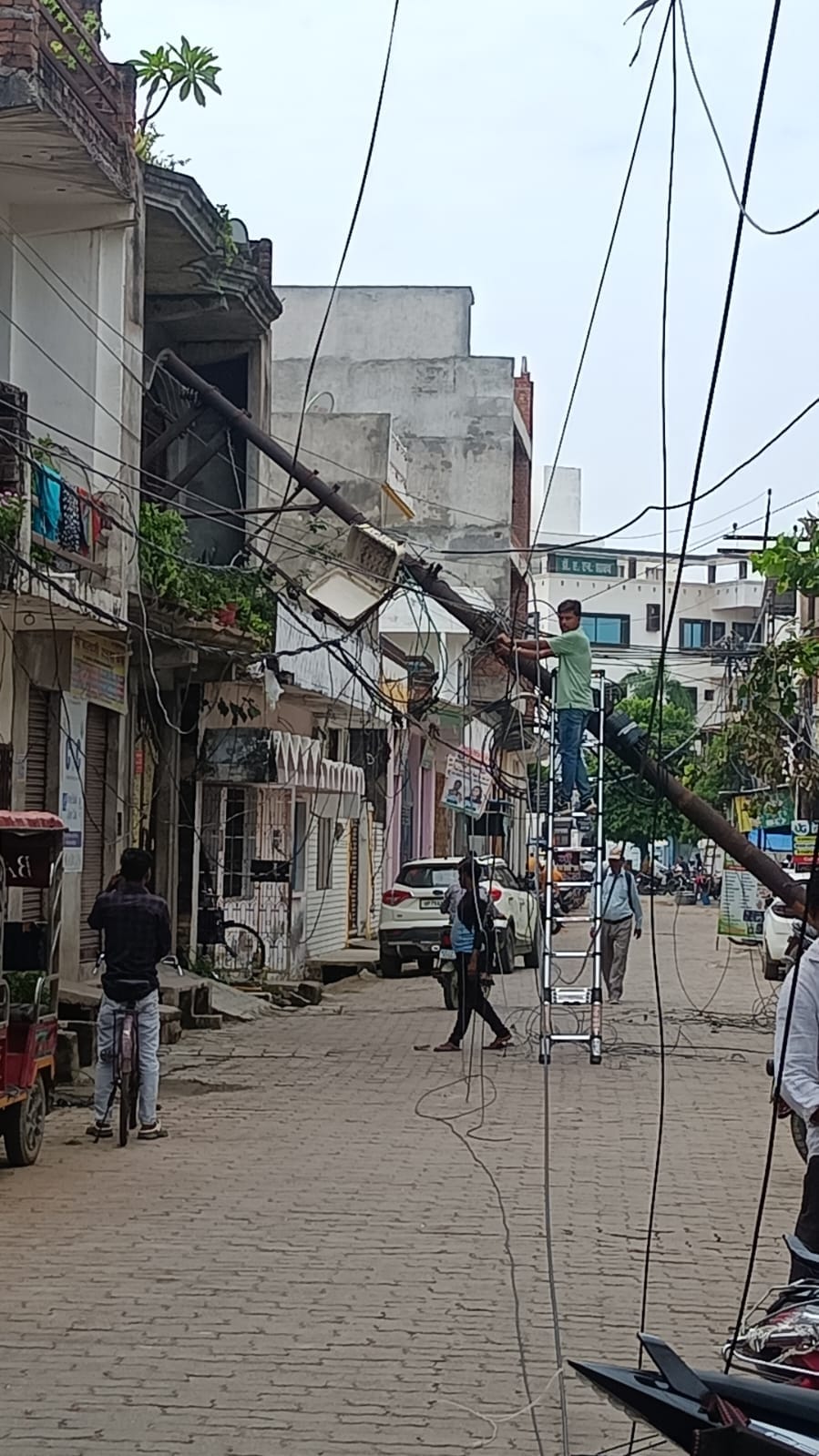 Dilapidated electricity pole falls on house; power out for two hours.