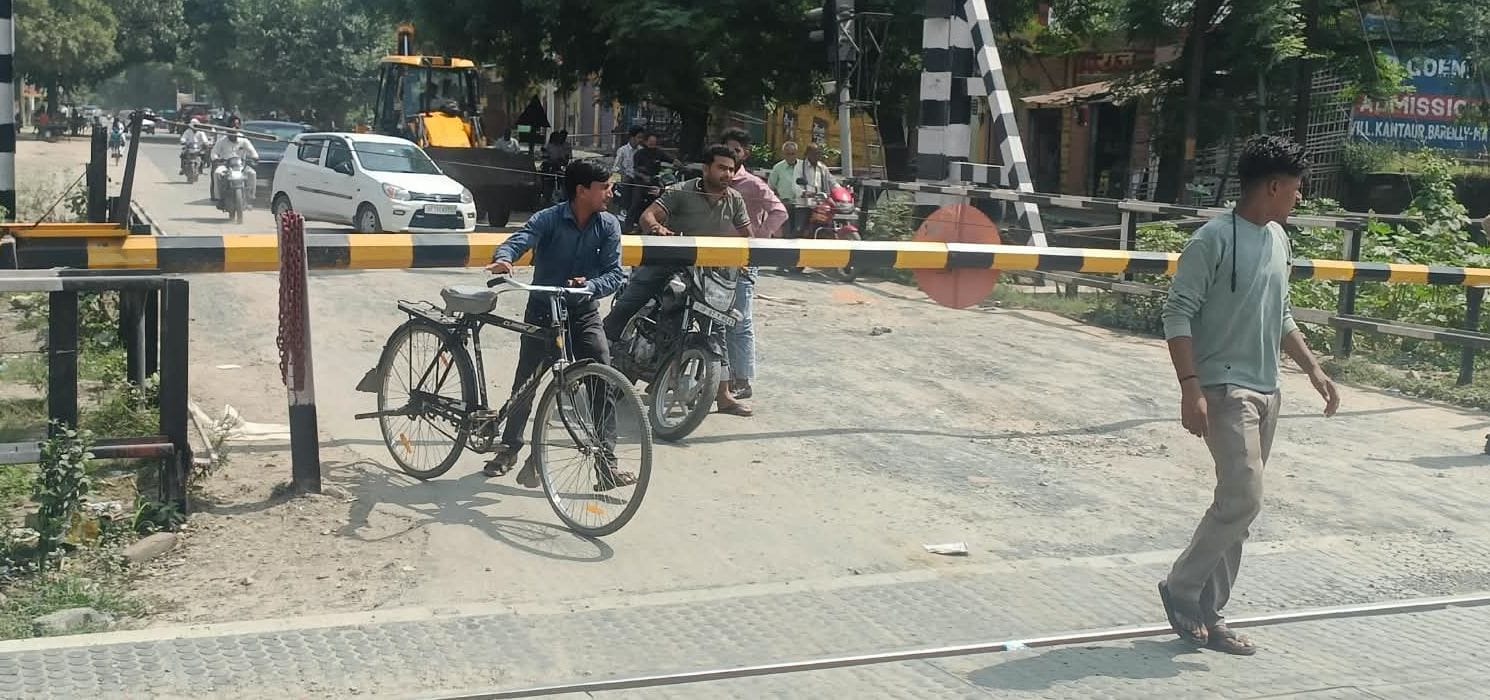 फोटो22कासगंज में आवास विकास क्रॉसिंग बंद होने पर रेलवे लाइन के बीचसे निकलता साइकिल सवार व युव