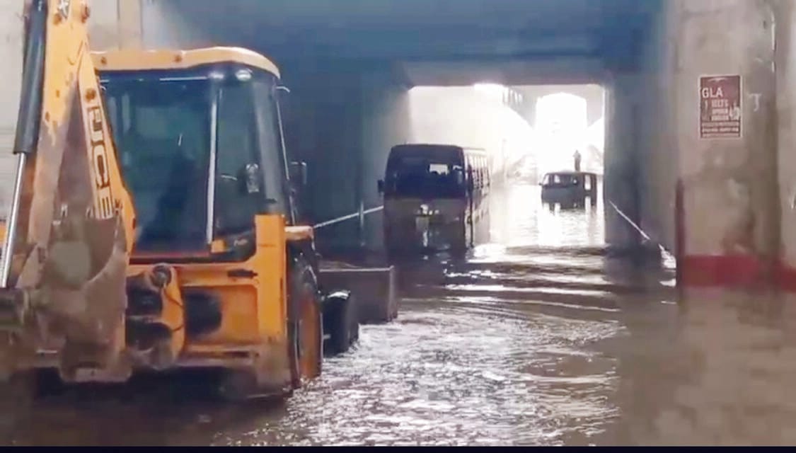 School bus carrying 30 children stuck in waterlogged underpass.
