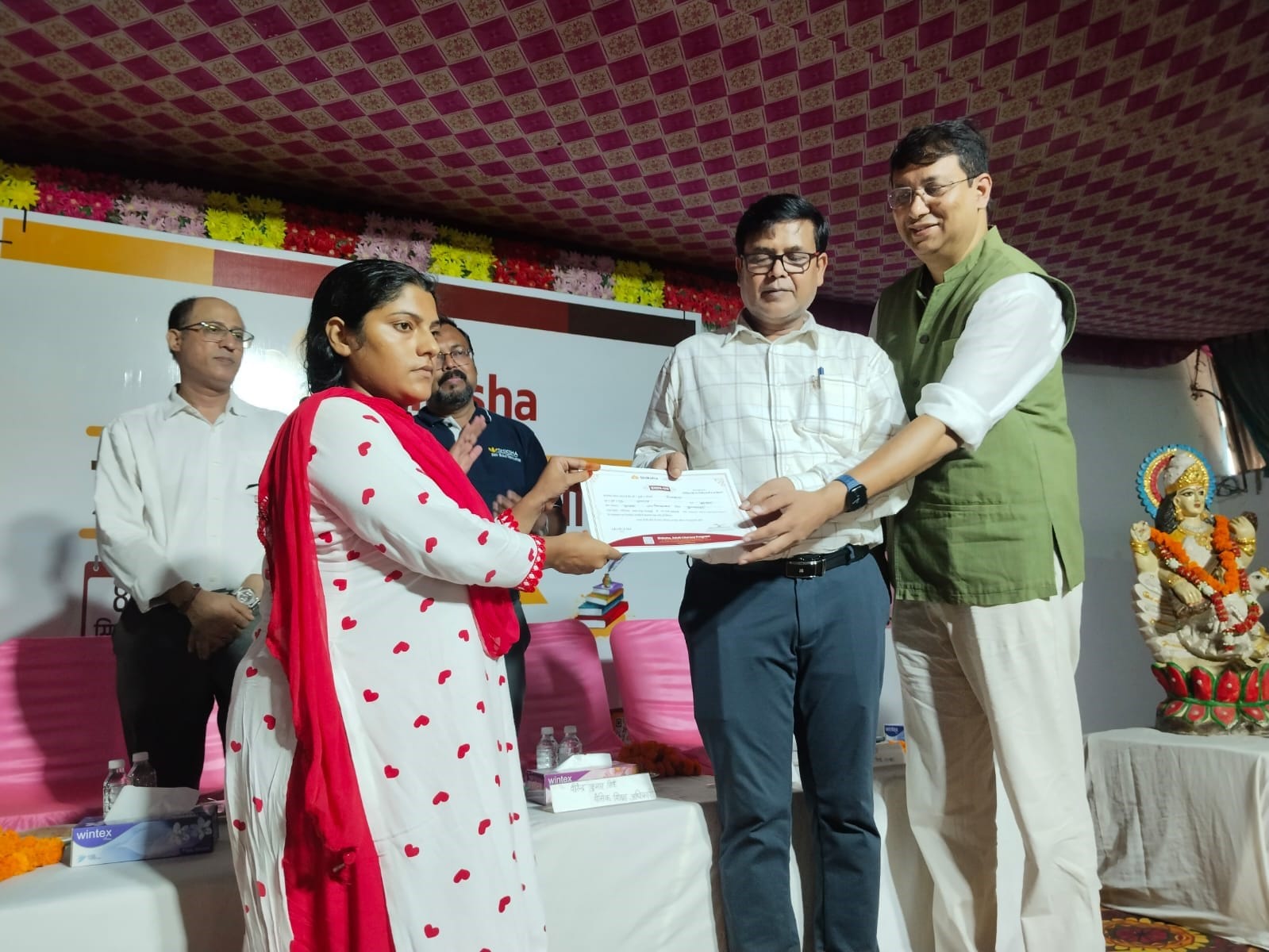 ककोड़ में नव-साक्षर महिला को मिले प्रमाण-पत्र प्रदान करते अतिथि। संवाद