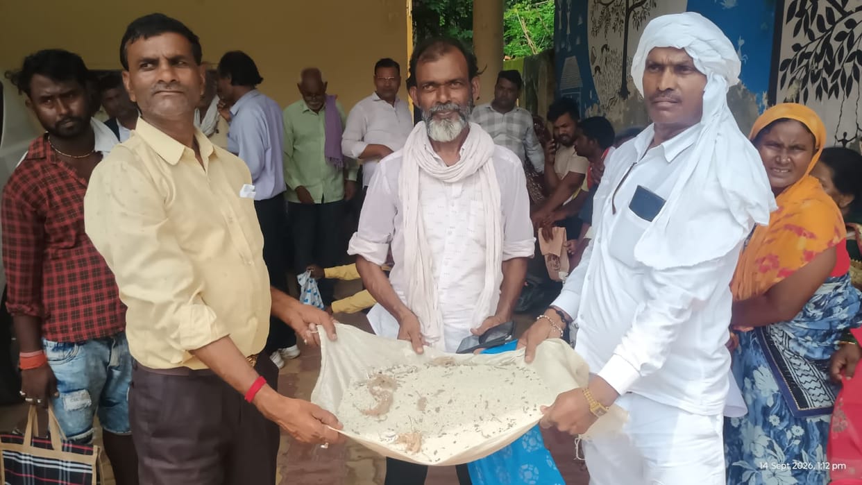 Villagers approach DM after receiving poor-quality rice from the ration shop.