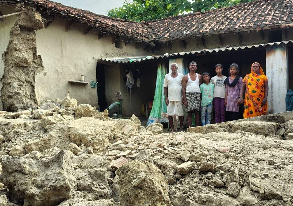 Mud house collapses in the rain; household belongings buried under the debris.