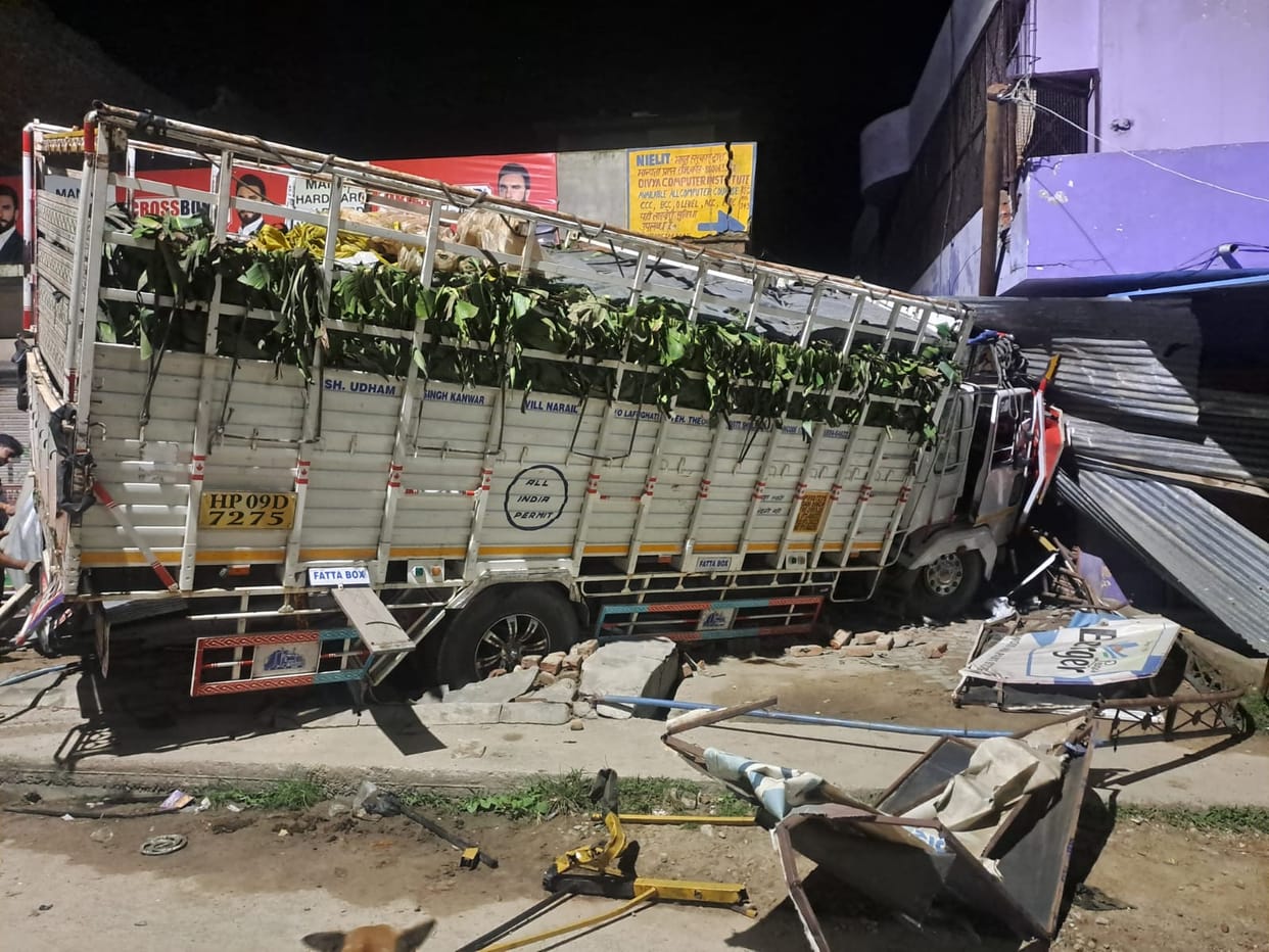 Wall and goods damaged after mini-truck crashes into shop.