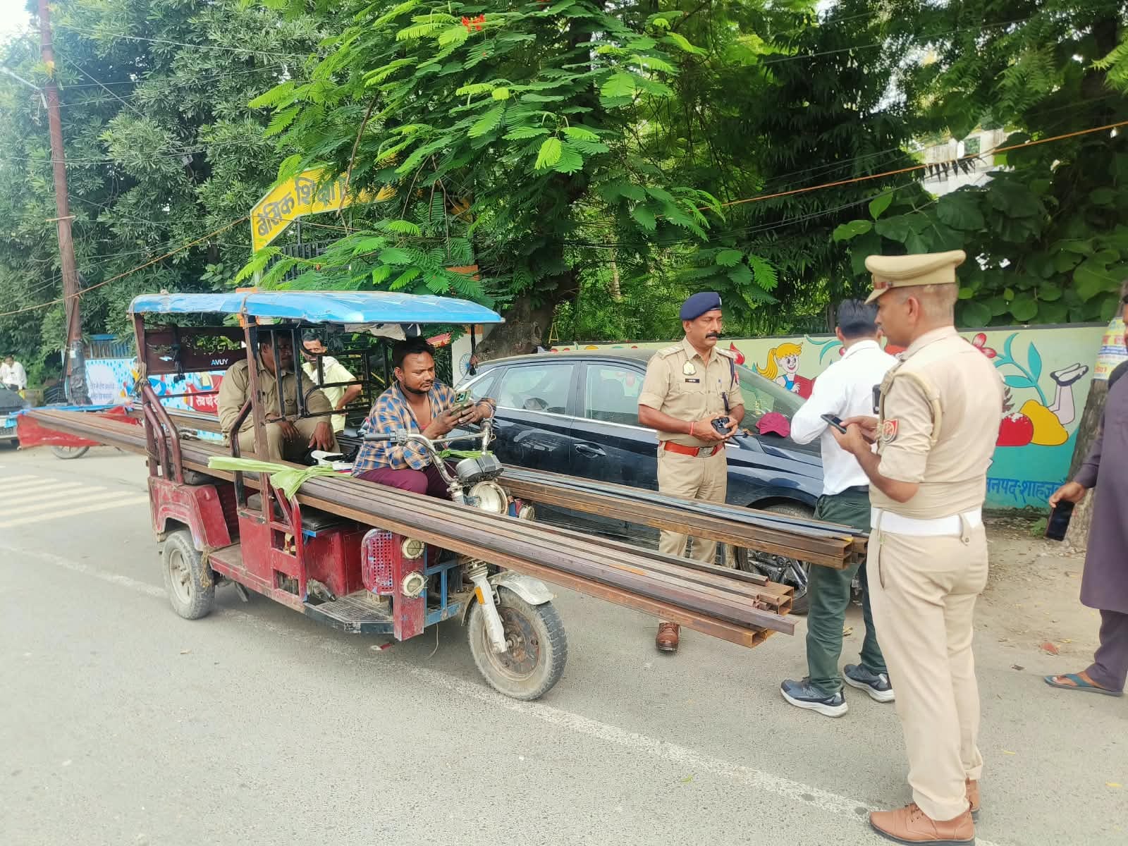 शाहजहांपुर में सरिया लदे ई-रिक्शे का चालान करते टीएसआई। स्रोत: पुलिस