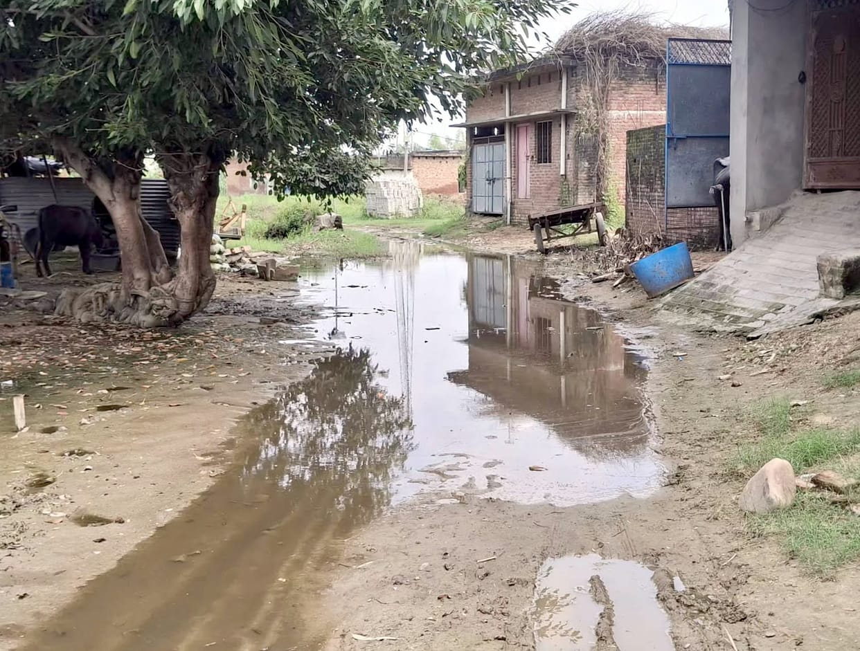 Unpaved roads in Shivpuri pose a problem, forcing villagers to walk in mud.